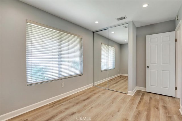 3810 Adams St, Lake Elsinore, CA 92530 - unfurnished bedroom featuring a closet, multiple windows, light wood-style flooring, and recessed lighting
