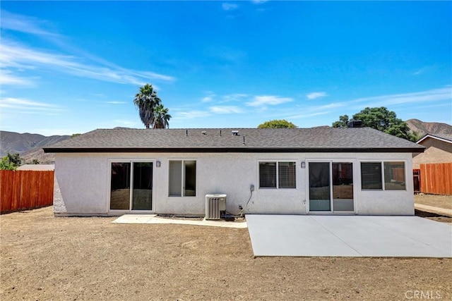 3810 Adams St, Lake Elsinore, CA 92530 - rear view of property featuring a fenced backyard, a patio area, stucco siding, a mountain view, and roof with shingles