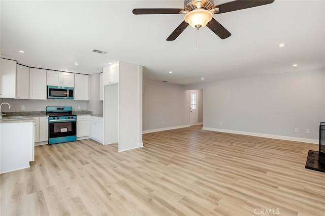 3810 Adams St, Lake Elsinore, CA 92530 - kitchen with appliances with stainless steel finishes, white cabinets, open floor plan, and recessed lighting