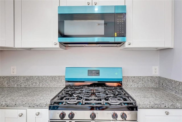 3810 Adams St, Lake Elsinore, CA 92530 - kitchen featuring appliances with stainless steel finishes, white cabinets, and light stone countertops