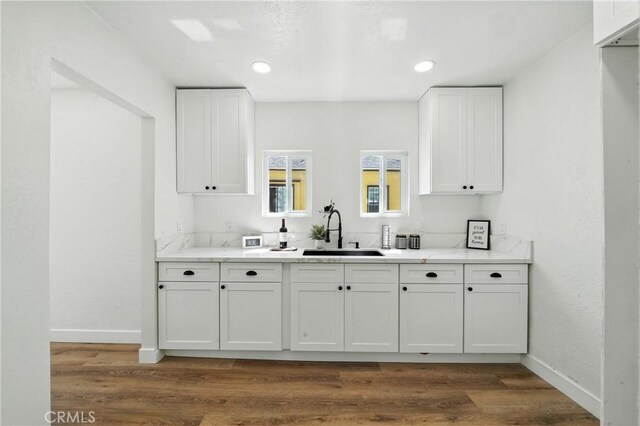 14581460 W 80th St, Los Angeles, CA 90047 - kitchen featuring white cabinetry, dark wood-style floors, and light stone counters