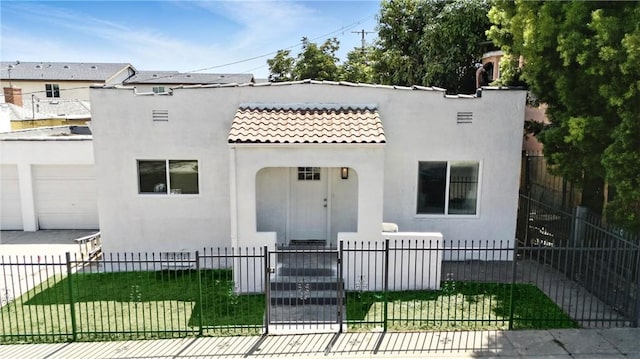 14581460 W 80th St, Los Angeles, CA 90047 - view of front of home featuring a tiled roof, stucco siding, a fenced front yard, and a garage