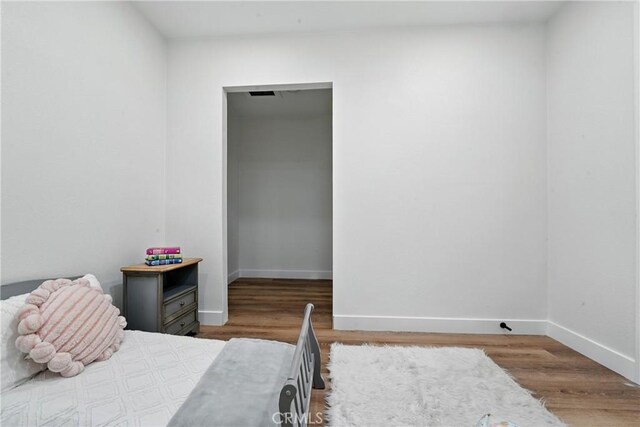 14581460 W 80th St, Los Angeles, CA 90047 - bedroom with baseboards and wood finished floors