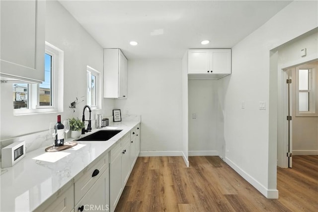 14581460 W 80th St, Los Angeles, CA 90047 - kitchen featuring light wood finished floors, white cabinets, light stone counters, and recessed lighting