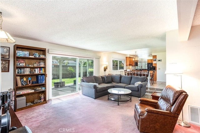 14772 Forrest Ln, Westminster, CA 92683 - living room featuring a textured ceiling, light colored carpet, and a chandelier