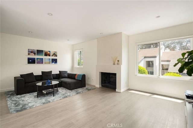 680 E Workman St, Covina, CA 91723 - living area with wood finished floors and a fireplace