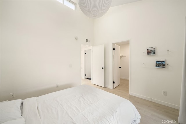 680 E Workman St, Covina, CA 91723 - bedroom featuring a high ceiling, light wood-style flooring, and a walk in closet