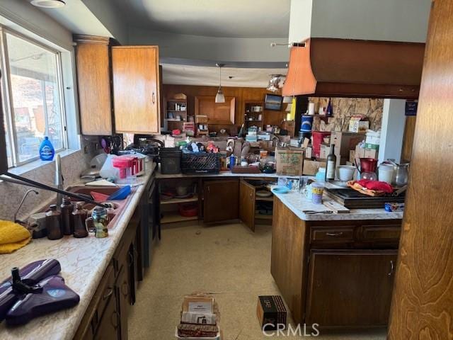 2089 Monterey Peninsula Dr, Corona, CA 92882 - kitchen featuring light countertops, brown cabinetry, and light carpet