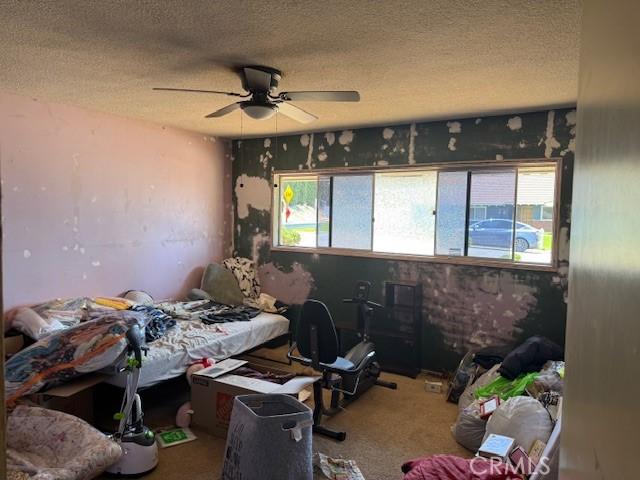 2089 Monterey Peninsula Dr, Corona, CA 92882 - bedroom with a textured ceiling, carpet floors, and a ceiling fan