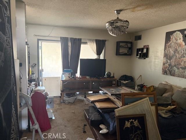 2089 Monterey Peninsula Dr, Corona, CA 92882 - carpeted dining room with a textured ceiling