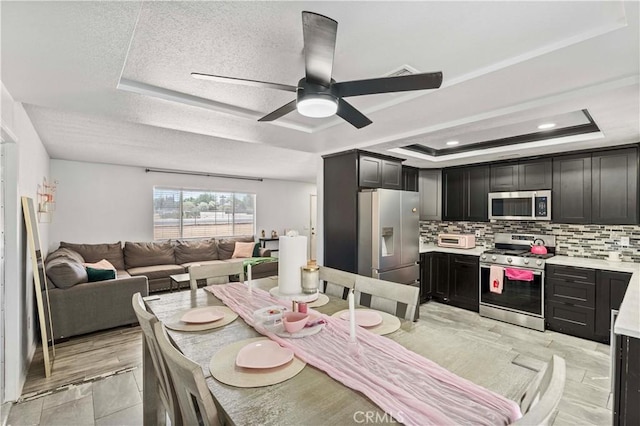 18396 Live Oak St, Hesperia, CA 92345 - dining space with a tray ceiling, ceiling fan, and a textured ceiling