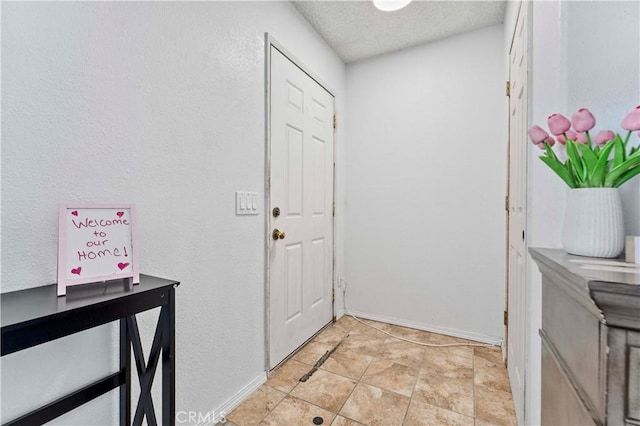 18396 Live Oak St, Hesperia, CA 92345 - entryway featuring a textured ceiling and baseboards