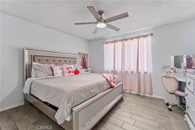 18396 Live Oak St, Hesperia, CA 92345 - bedroom with a textured ceiling, wood tiled floors, a desk, and a ceiling fan