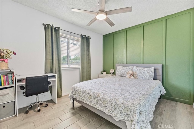 18396 Live Oak St, Hesperia, CA 92345 - bedroom with light wood finished floors, a desk, a textured ceiling, and ceiling fan