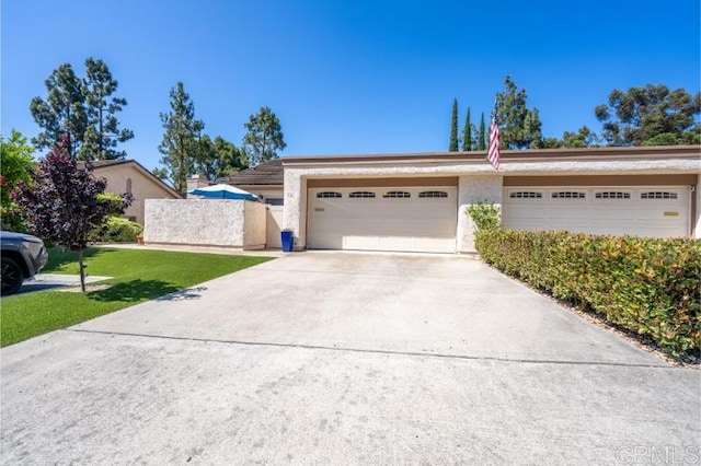 814 Cardamom Ct, Chula Vista, CA 91910 - view of front of house featuring stucco siding, concrete driveway, an attached garage, and a front lawn