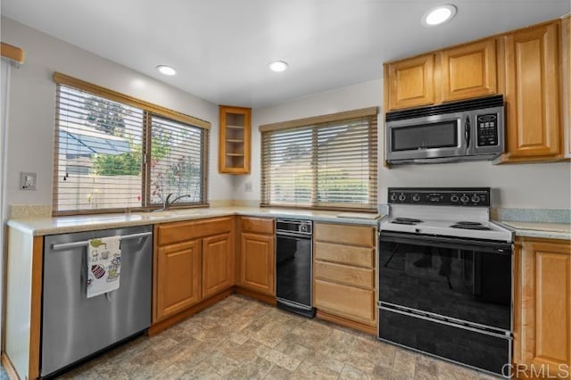 814 Cardamom Ct, Chula Vista, CA 91910 - kitchen with stainless steel appliances, light countertops, recessed lighting, stone finish flooring, and glass insert cabinets