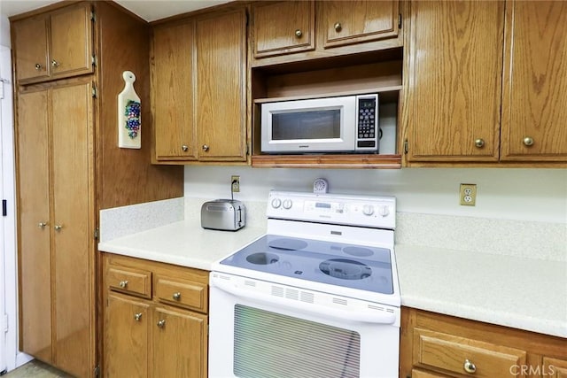 511 W Puente St Unit 4, Covina, CA 91722 - kitchen featuring white appliances, light countertops, and brown cabinets