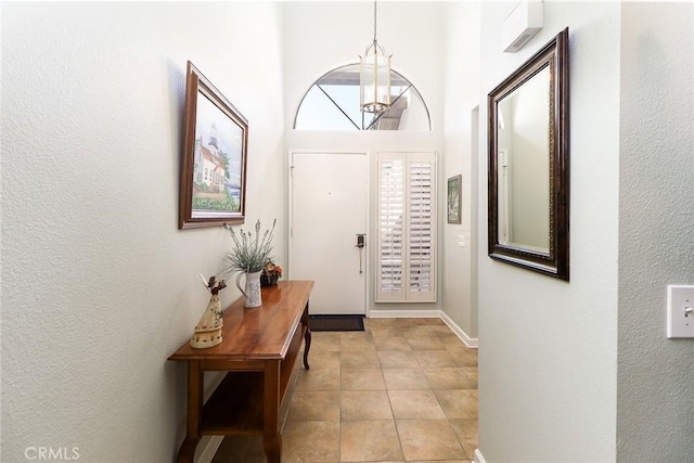 511 W Puente St Unit 4, Covina, CA 91722 - entryway featuring a chandelier, light tile patterned flooring, and a textured wall