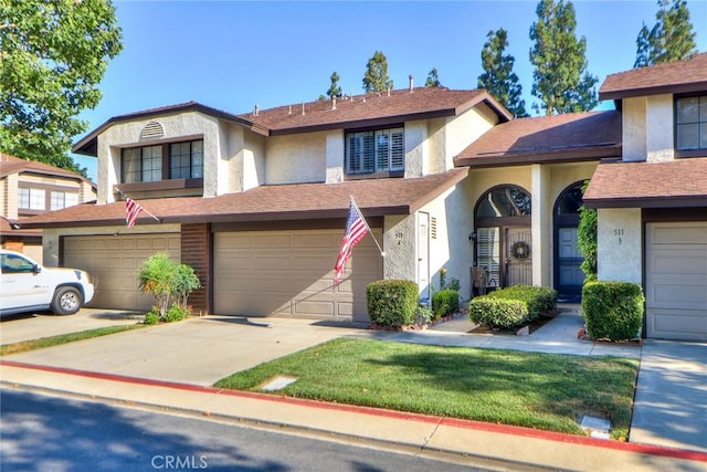 511 W Puente St Unit 4, Covina, CA 91722 - view of front of house featuring an attached garage, stucco siding, concrete driveway, and a front lawn
