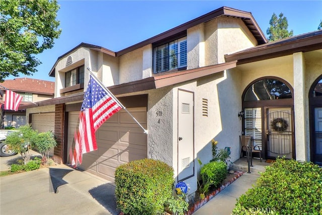 511 W Puente St Unit 4, Covina, CA 91722 - view of front facade with stucco siding, concrete driveway, and an attached garage
