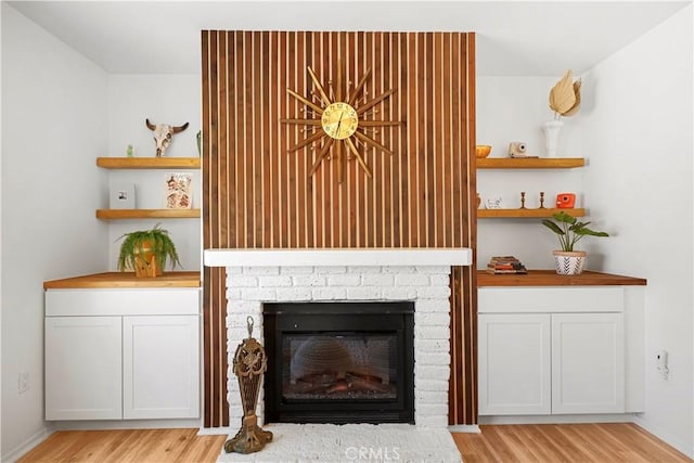 63608 Jadeite St, Joshua Tree, CA 92252 - detailed view of wood finished floors and a brick fireplace