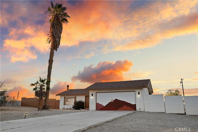 63608 Jadeite St, Joshua Tree, CA 92252 - view of front of home with an attached garage, concrete driveway, and stucco siding