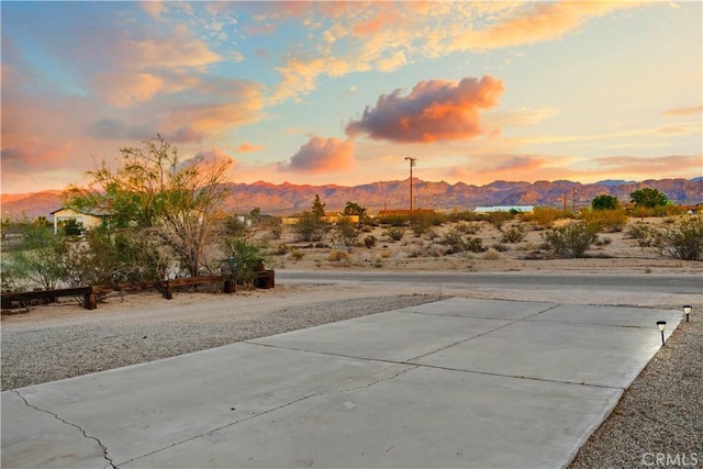 63608 Jadeite St, Joshua Tree, CA 92252 - yard at dusk with a mountain view and a patio area