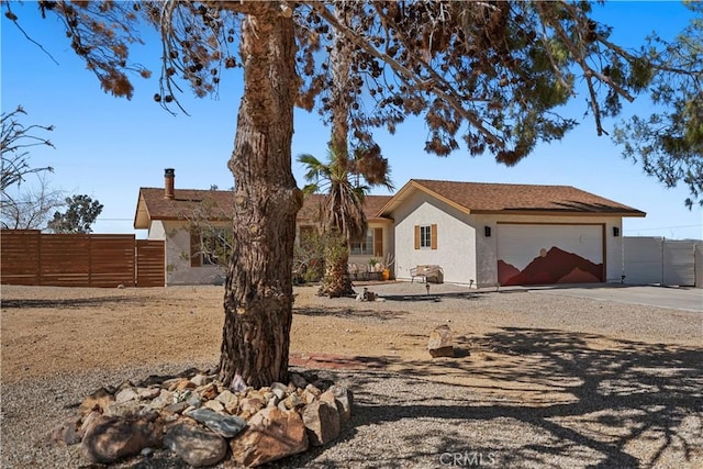 63608 Jadeite St, Joshua Tree, CA 92252 - ranch-style home featuring stucco siding, an attached garage, and driveway