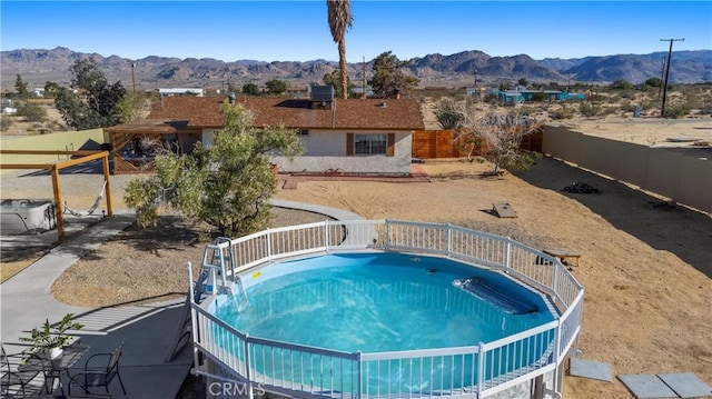 63608 Jadeite St, Joshua Tree, CA 92252 - view of swimming pool featuring a mountain view and a fenced backyard