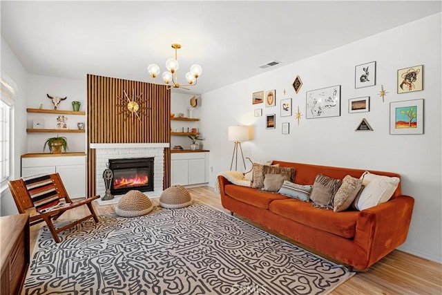 63608 Jadeite St, Joshua Tree, CA 92252 - living room featuring a chandelier, light wood-style floors, and a fireplace