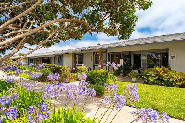 130 E Bay Blvd, Port Hueneme, CA 93041 - rear view of property featuring stucco siding and a lawn