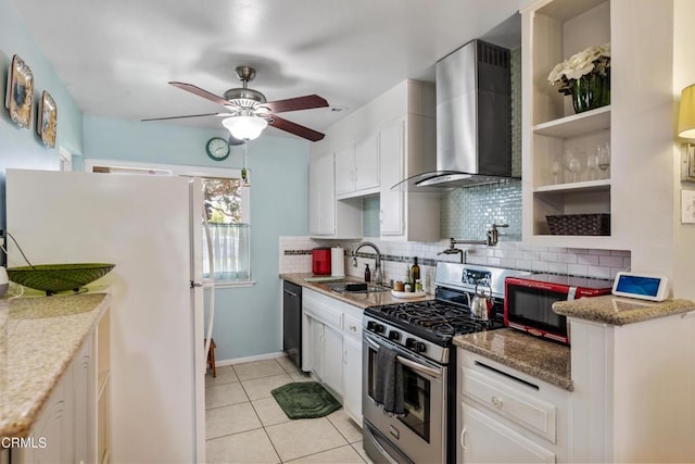 130 E Bay Blvd, Port Hueneme, CA 93041 - kitchen with wall chimney exhaust hood, stainless steel gas stove, freestanding refrigerator, backsplash, and white cabinets