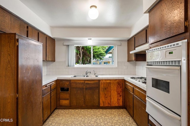 1921 Lincoln Ct, Oxnard, CA 93033 - kitchen with a warming drawer, white appliances, decorative backsplash, and under cabinet range hood