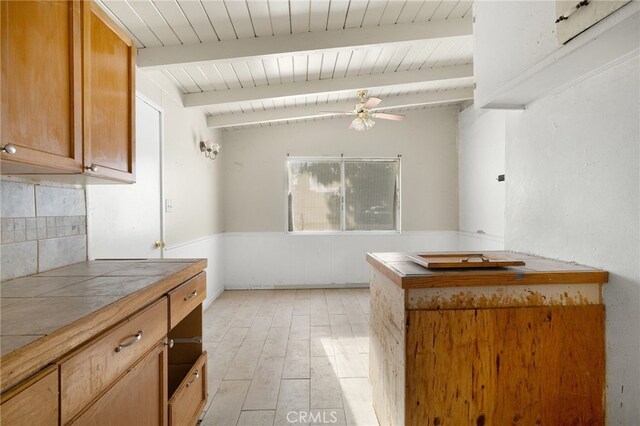 609 S Lassen St, Willows, CA 95988 - kitchen featuring wood ceiling, ceiling fan, decorative backsplash, tile counters, and brown cabinetry