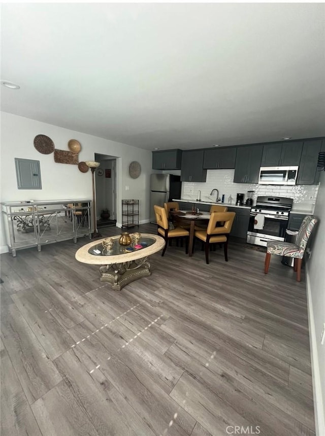 1303 W 109th Pl, Los Angeles, CA 90044 - living area featuring wood finished floors and baseboards