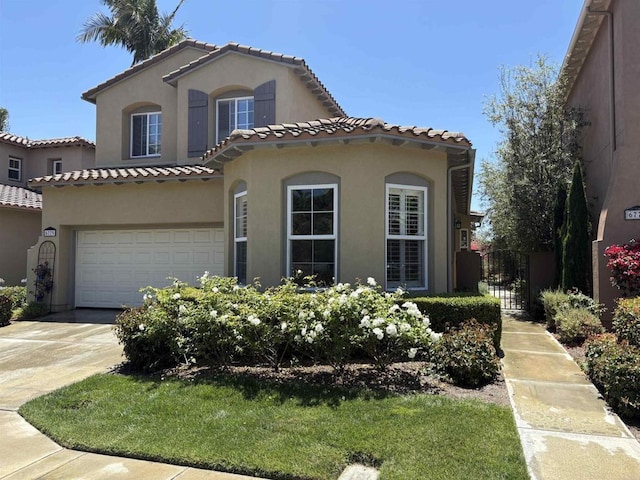 6779 Palermi Pl, Carlsbad, CA 92011 - mediterranean / spanish home featuring stucco siding, an attached garage, concrete driveway, a tiled roof, and a gate
