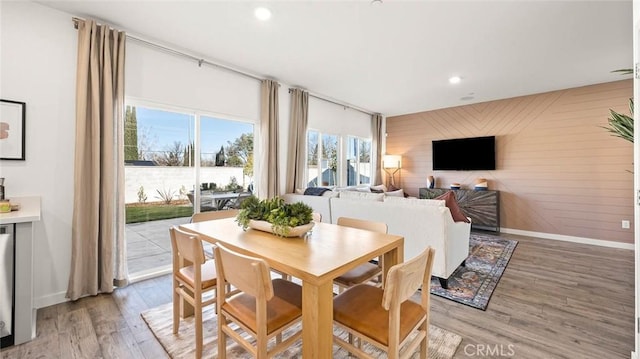 770 Pico Pl, Chico, CA 95928 - dining room featuring an accent wall, light wood-style floors, recessed lighting, and wood walls