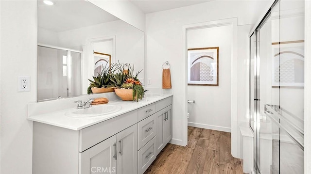 770 Pico Pl, Chico, CA 95928 - bathroom featuring double vanity, a shower stall, and wood finished floors