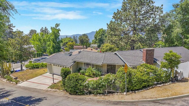 2302 Jayma Ln, La Crescenta, CA 91214 - view of front of property featuring a tiled roof, an attached garage, a chimney, driveway, and a mountain view