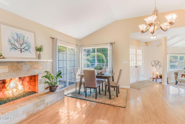 2302 Jayma Ln, La Crescenta, CA 91214 - dining room with wood finished floors, lofted ceiling, a chandelier, and a tiled fireplace