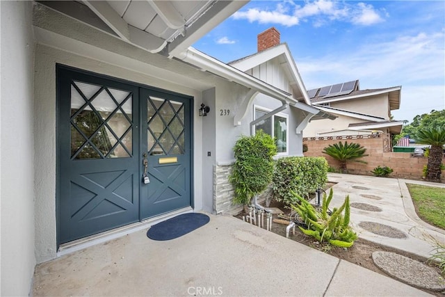239 N Basilio Ave, San Dimas, CA 91773 - doorway to property featuring a chimney and stucco siding