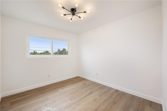 239 N Basilio Ave, San Dimas, CA 91773 - unfurnished room with light wood-style flooring and a chandelier