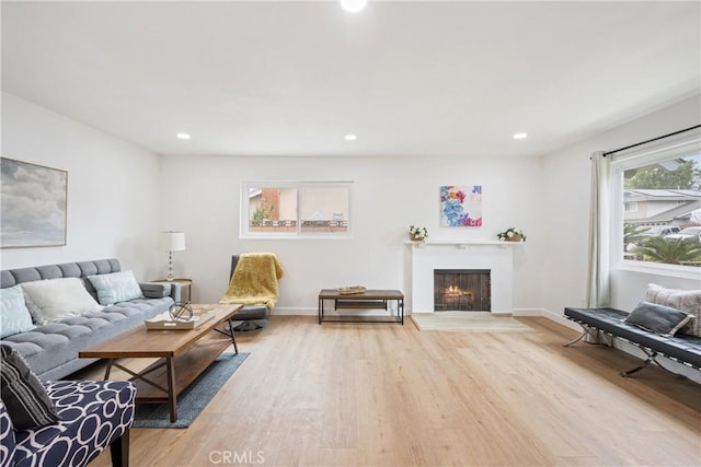 239 N Basilio Ave, San Dimas, CA 91773 - living area with light wood-type flooring, a fireplace with flush hearth, and recessed lighting
