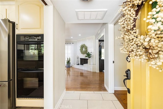8841 White Oak Ave, Sherwood Forest, CA 91325 - foyer entrance featuring light tile patterned floors, crown molding, and a tiled fireplace