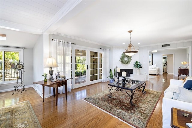 8841 White Oak Ave, Sherwood Forest, CA 91325 - living room with french doors, wood finished floors, ornamental molding, beam ceiling, and a large fireplace