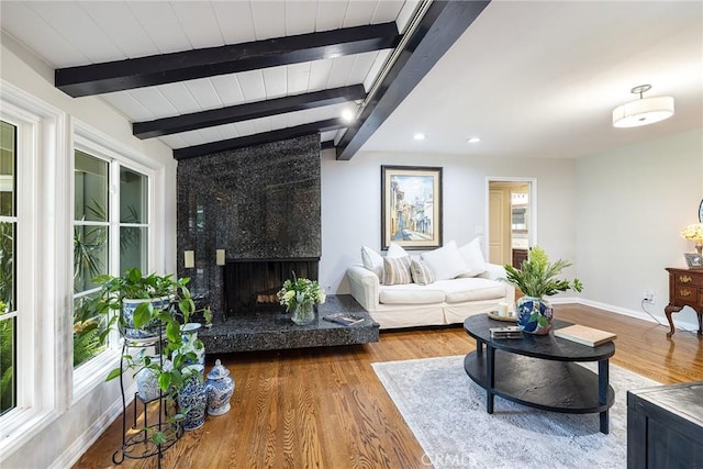 8841 White Oak Ave, Sherwood Forest, CA 91325 - living room featuring a premium fireplace, beam ceiling, wood finished floors, and recessed lighting