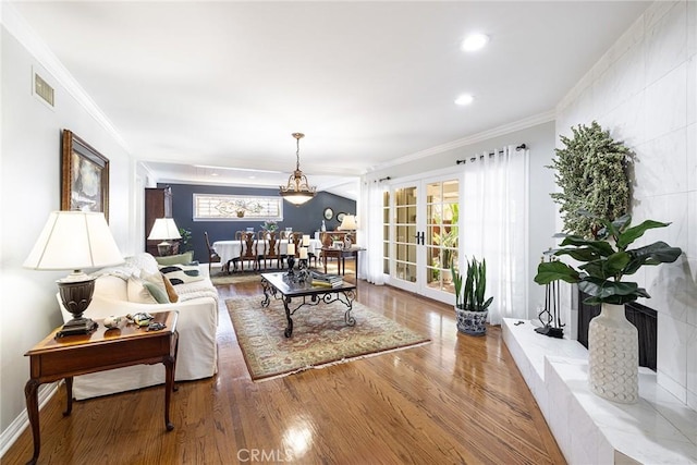 8841 White Oak Ave, Sherwood Forest, CA 91325 - living area with crown molding, wood finished floors, and recessed lighting