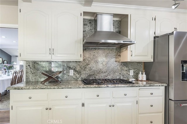 8841 White Oak Ave, Sherwood Forest, CA 91325 - kitchen with wall chimney range hood, stainless steel appliances, tasteful backsplash, white cabinetry, and light stone counters