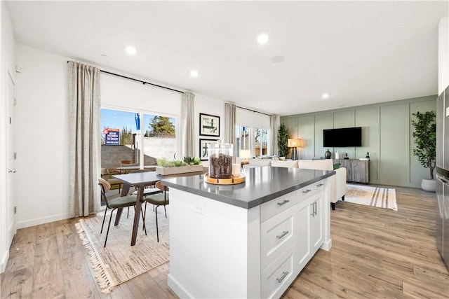 956 Pico Pl, Chico, CA 95928 - kitchen featuring dark countertops, a center island, light wood finished floors, white cabinetry, and recessed lighting