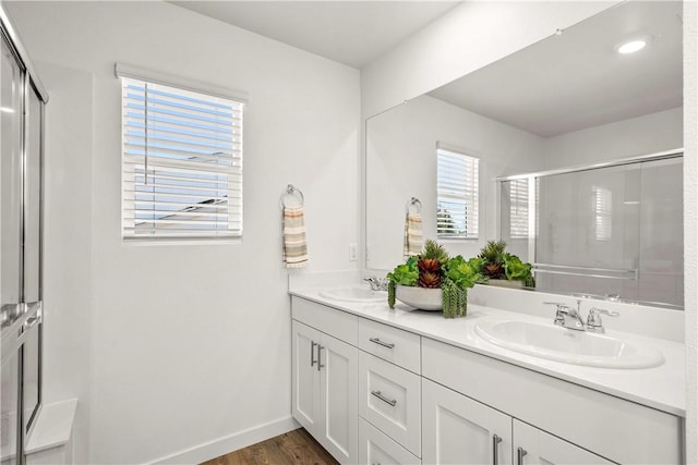 956 Pico Pl, Chico, CA 95928 - bathroom with double vanity, a shower with shower door, wood finished floors, and recessed lighting